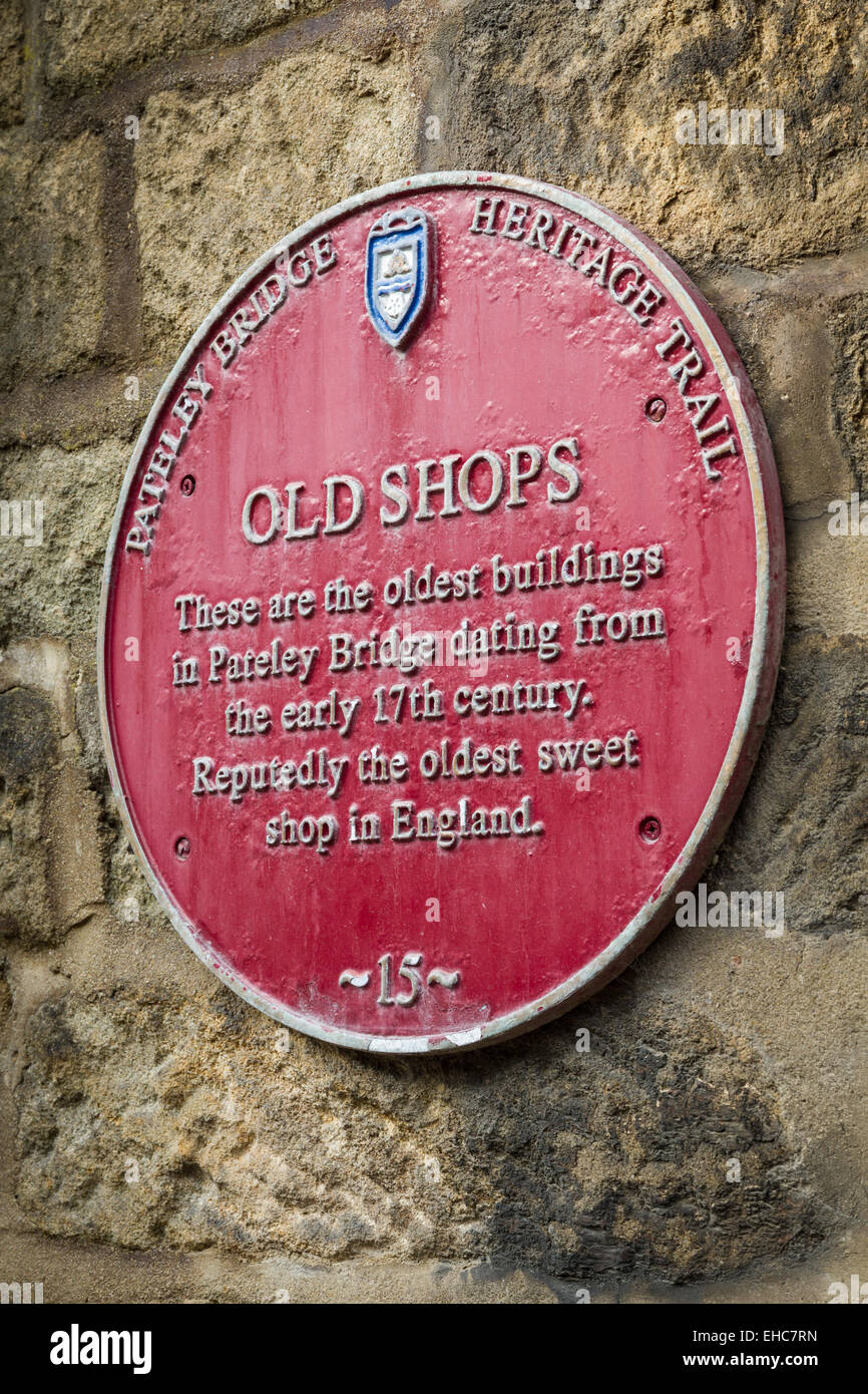 Heritage Plaque on the wall of the oldest shops in Pateley Bridge Stock Photo
