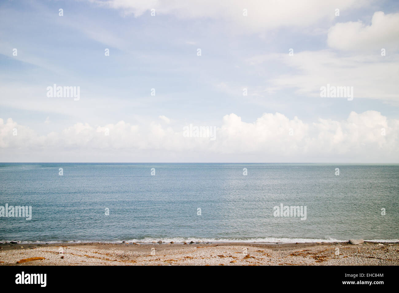 beach sea ocean cloudy blue sky Stock Photo - Alamy