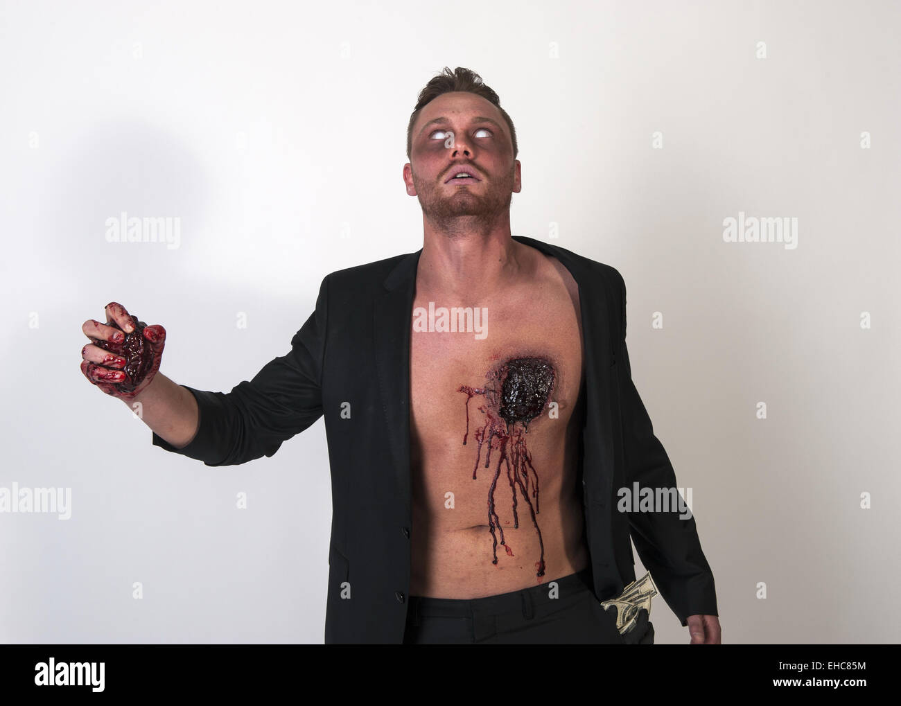 A zombie is tearing his heart out of his body Stock Photo