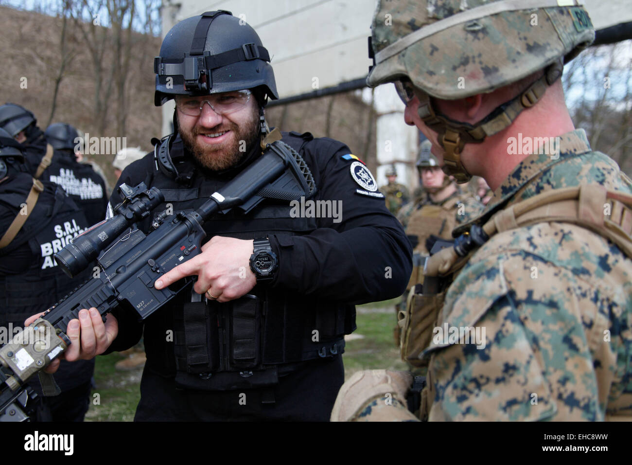 A US Marine explains the operation of an M27 automatic rifle to a member of the Romanian Jandarmeria at the Romanian intelligence service shooting range February 26, 2015 in Bucharest, Romania. Stock Photo