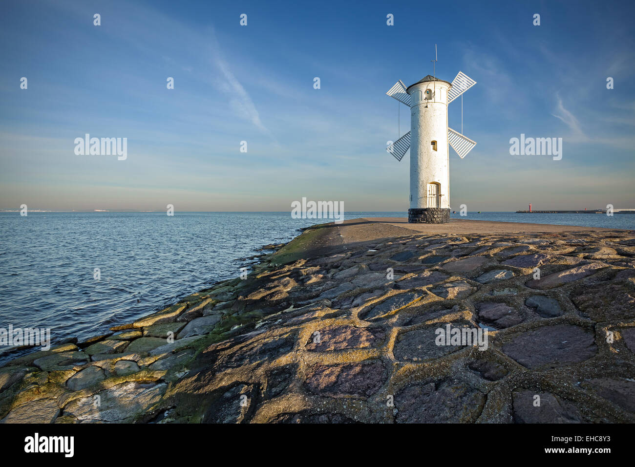 Sunrise on the coast, lighthouse windmill in Swinoujscie, Poland. Stock Photo