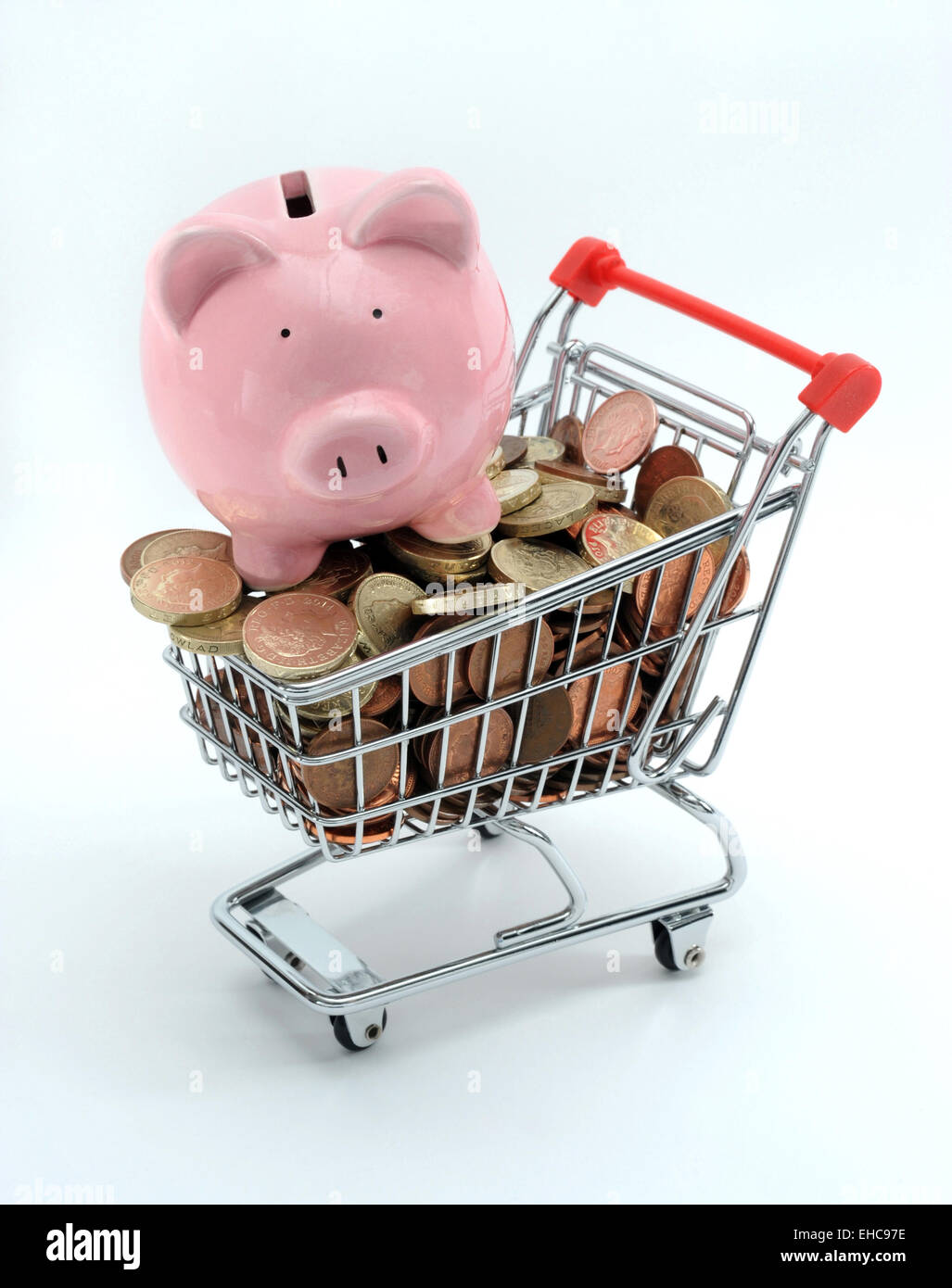 PIGGYBANK ON SUPERMARKET SHOPPING TROLLEY RE PENSIONS INCOMES FOOD PRICES SAVINGS INVESTMENTS ANNUITY PENSION POT MONEY POUND UK Stock Photo