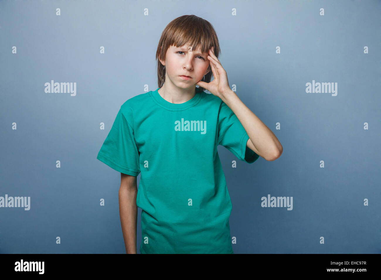 Boy, teenager, twelve years old, a in green tshirt holding Stock Photo
