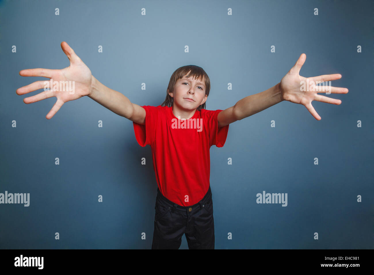 boy, teenager, twelve years old, wearing red shirt, stretched Stock