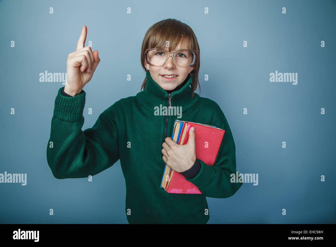 teenager boy brown hair European appearance in green sweater wit Stock Photo