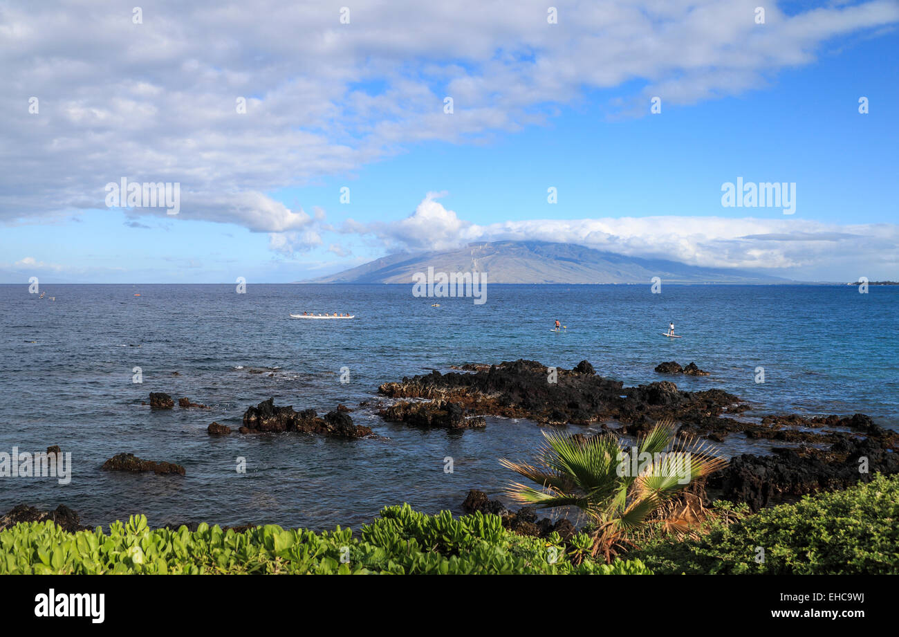 Snorkelers, outrigger canoe and stand up paddle boarders off Wailea, Maui Stock Photo