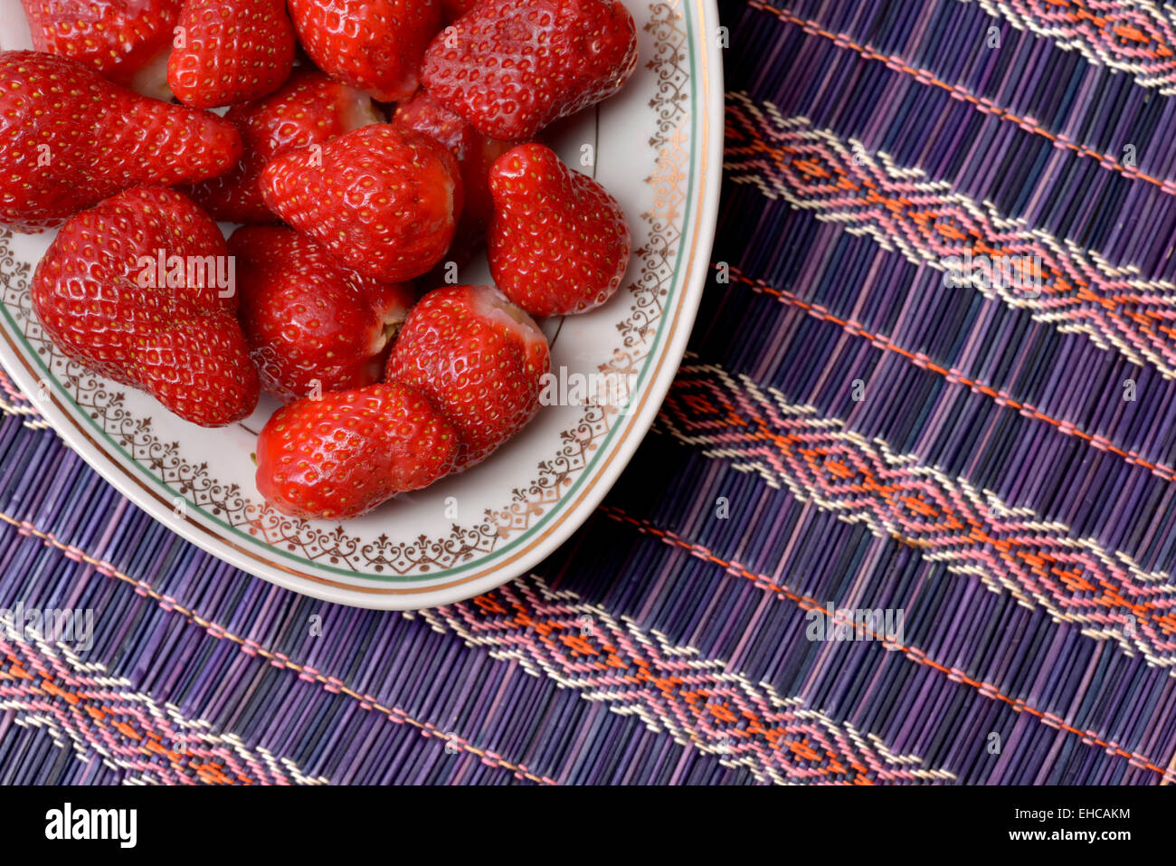 Fresh strawberries placed in a white ceramic dish with model Stock ...