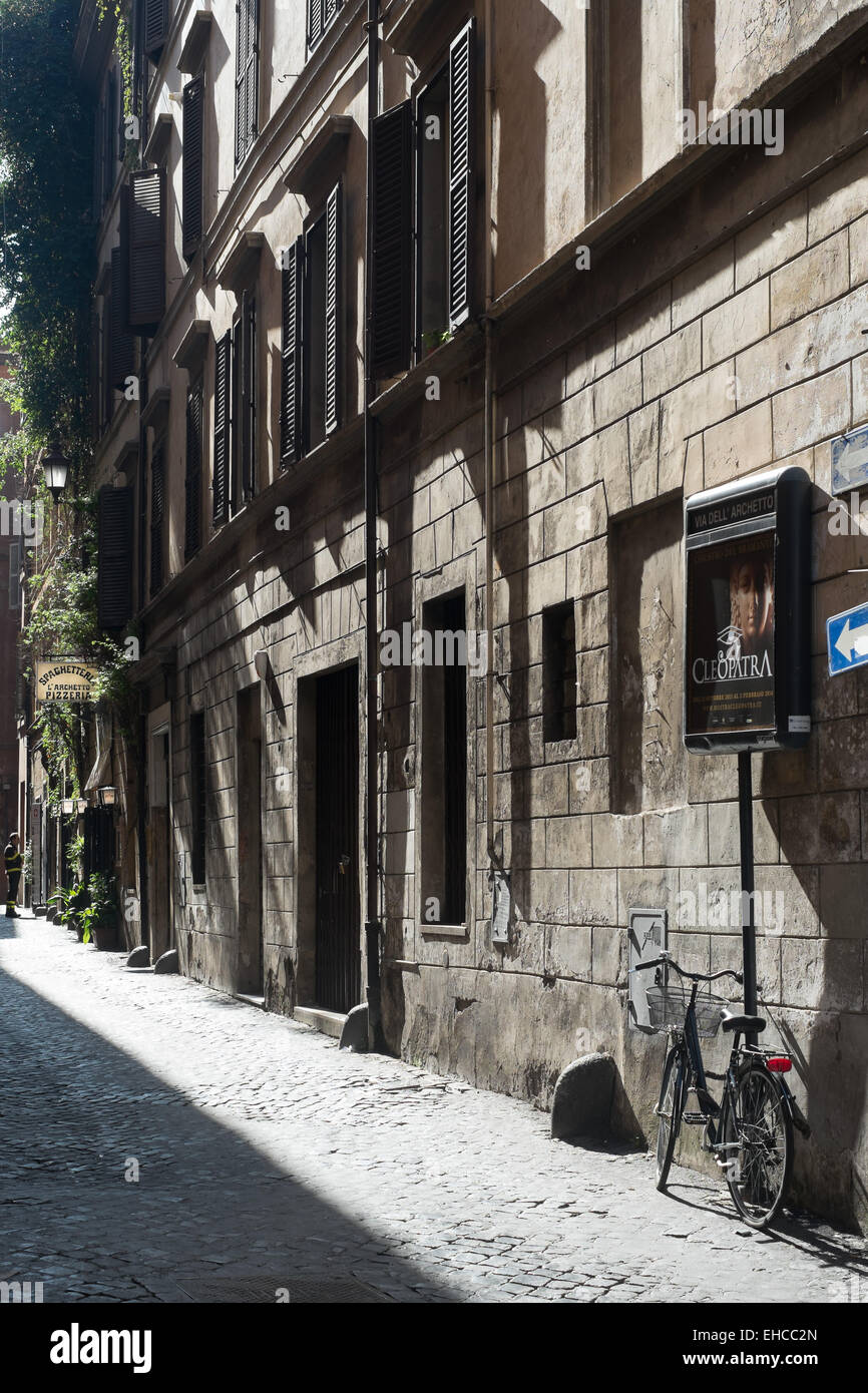 Bicycle parked on a cobblestone road in downtown Rome Italy. Stock Photo