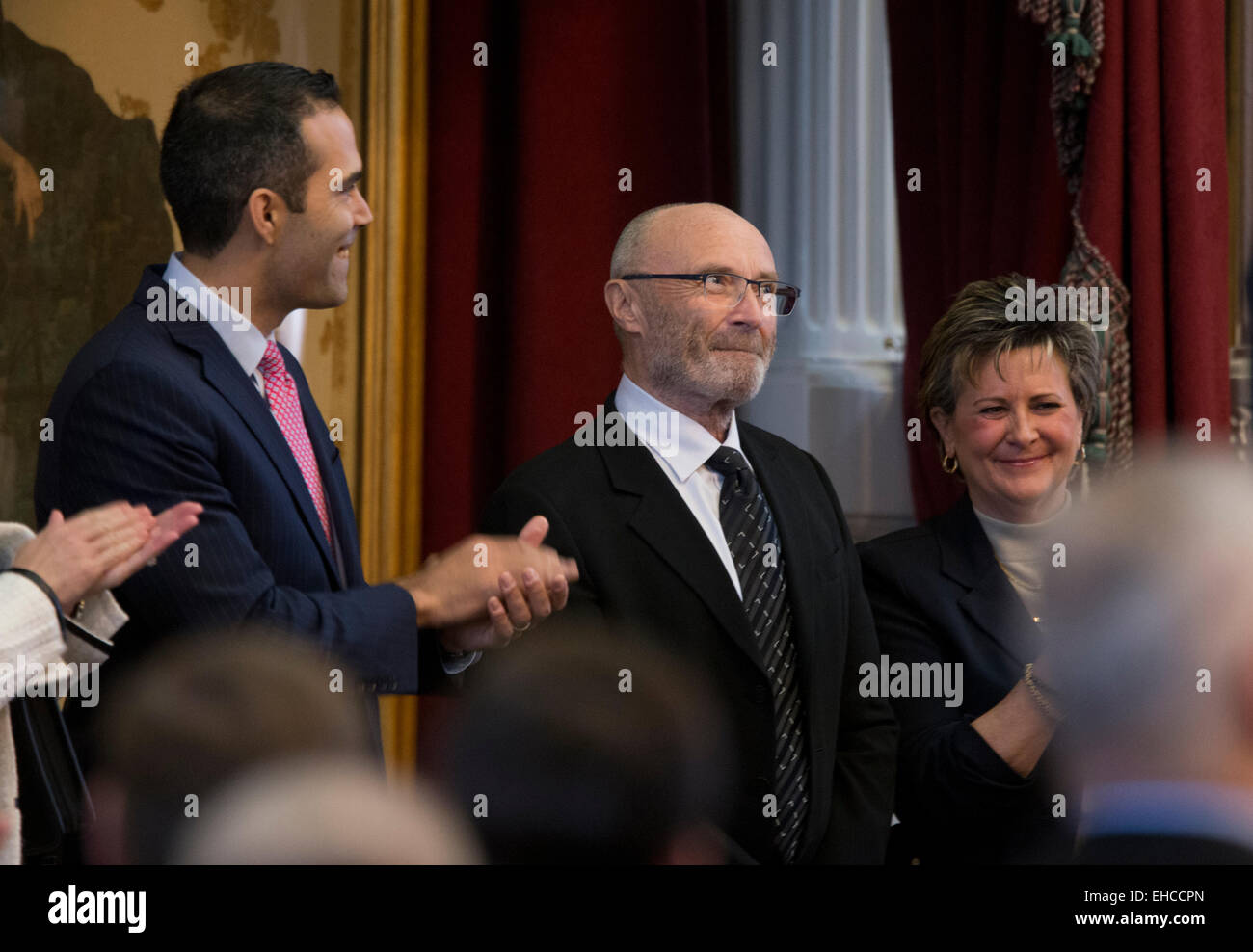 British pop singer Phil Collins, center, accepts title of Honorary Texan from the Texas Legislature. Stock Photo