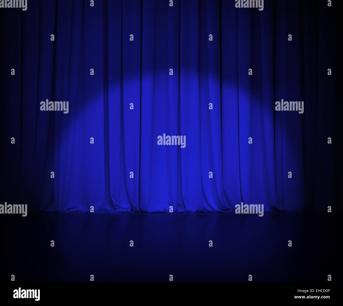 theatre dark blue curtain or drapes with light spot Stock Photo