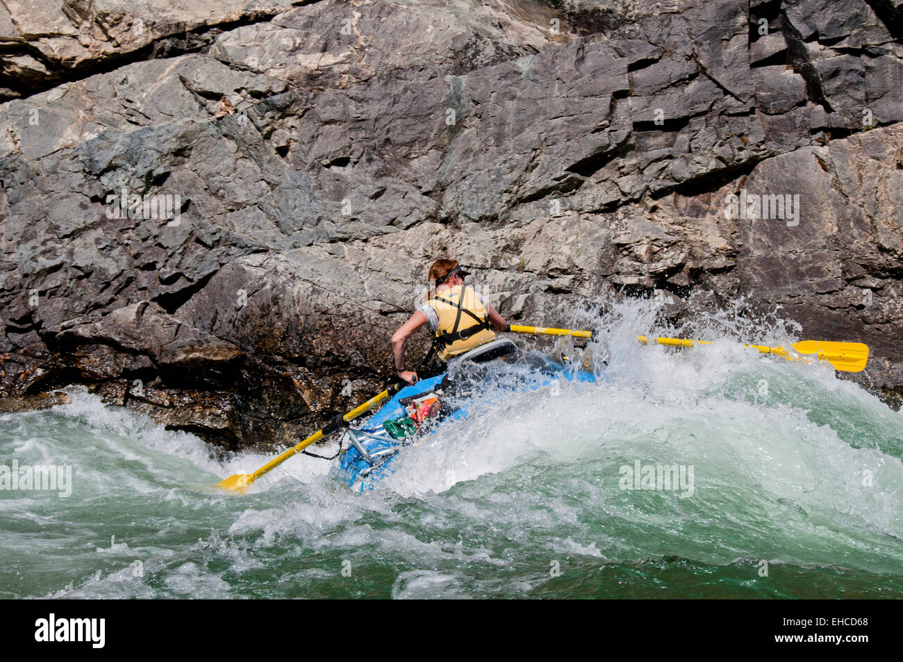 Woman rafter rowing through Upper Cliffside Rapid (class IV) on the Middle Fork of the Salmon River, Idaho Stock Photo
