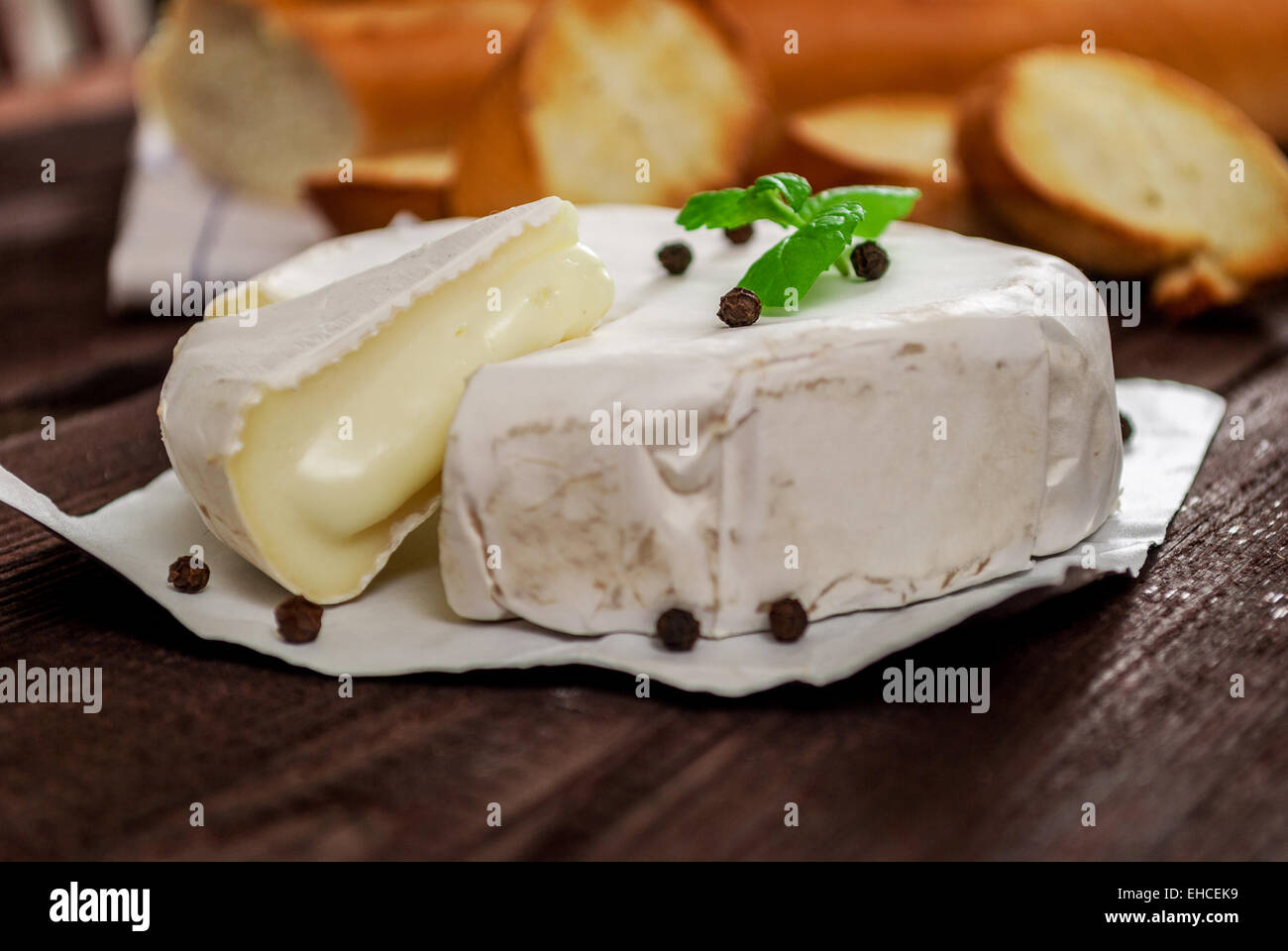 French traditional camembert cheese with baguette on wood table Stock Photo