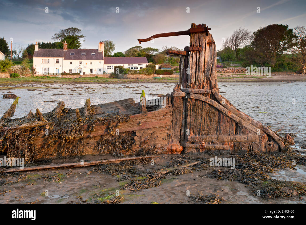 Wreck of The Seven Sisters and Holiday Cottages at Moel y don, Menai Straits, Anglesey, North Wales, UK Stock Photo