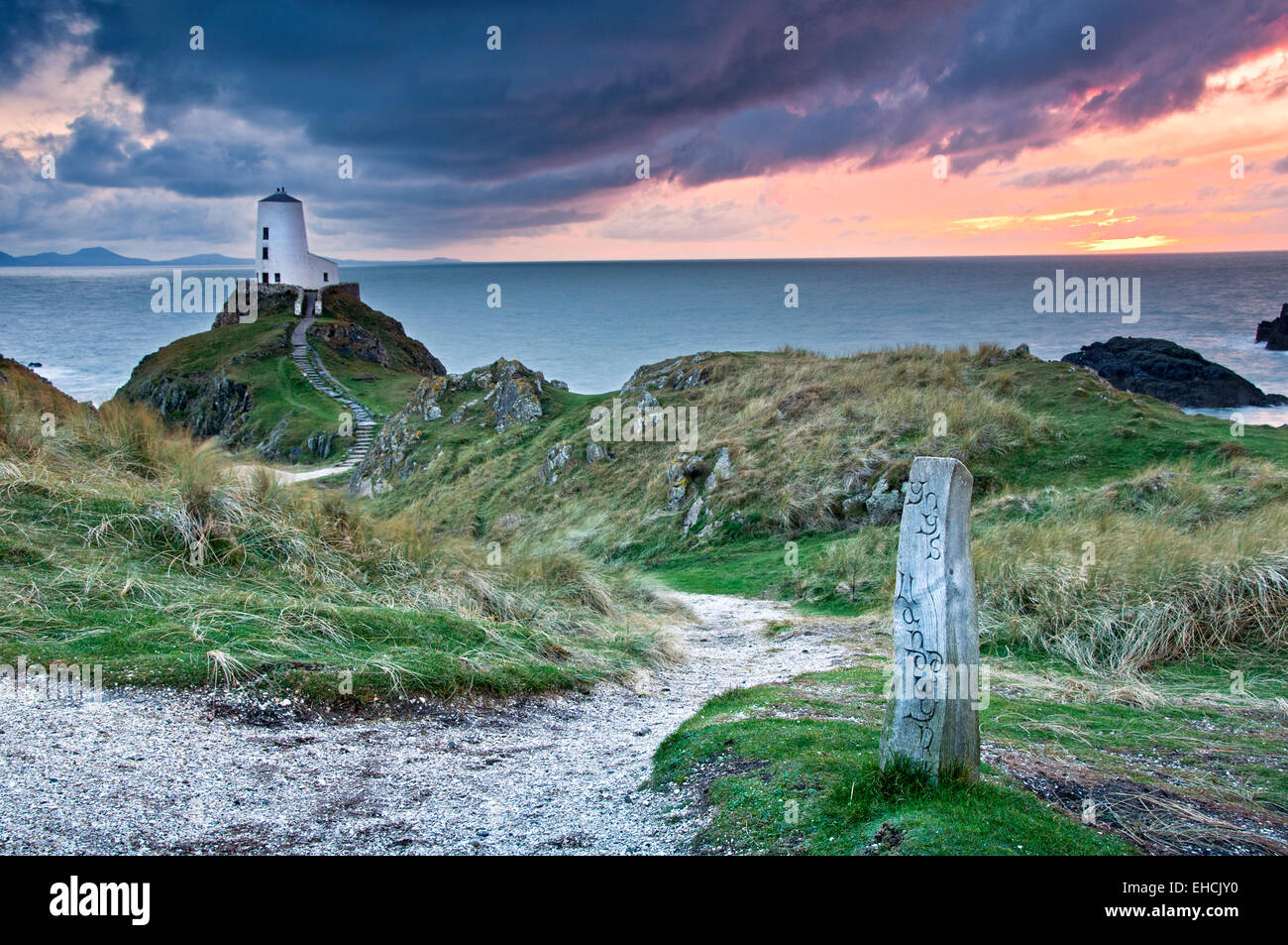 Tŵr Mawr Lighthouse at Sunset backed by The Lleyn Peninsula, Llanddwyn Island, Newborough, Anglesey, North Wales, UK Stock Photo