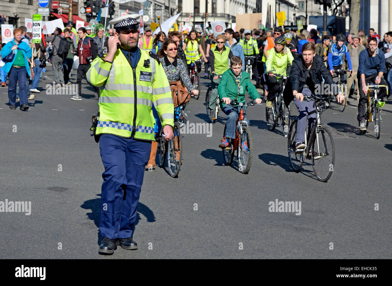 London, 7th March. Time To Act climate march through London to Parliament for a rally. Metropolitan police officer Stock Photo