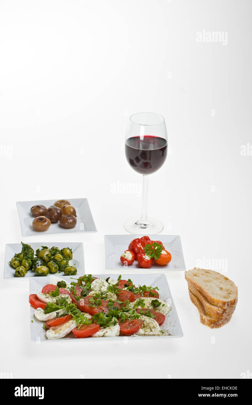 antipasti misti and bread on white plates Stock Photo