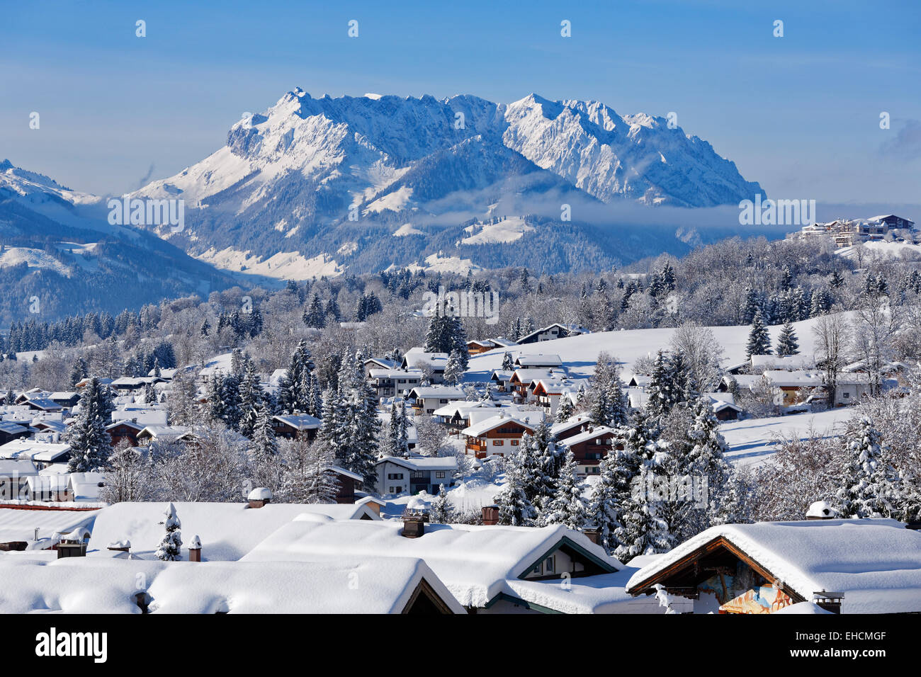 Townscape in winter, the Kaiser mountains in Tyrol at the back, Reit im Winkl, Chiemgau, Upper Bavaria, Bavaria, Germany Stock Photo