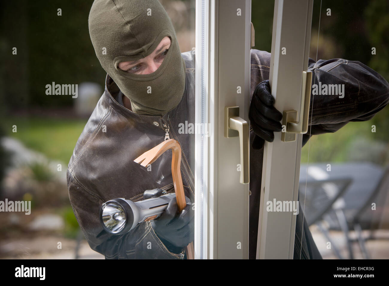 Burglar at a window Stock Photo