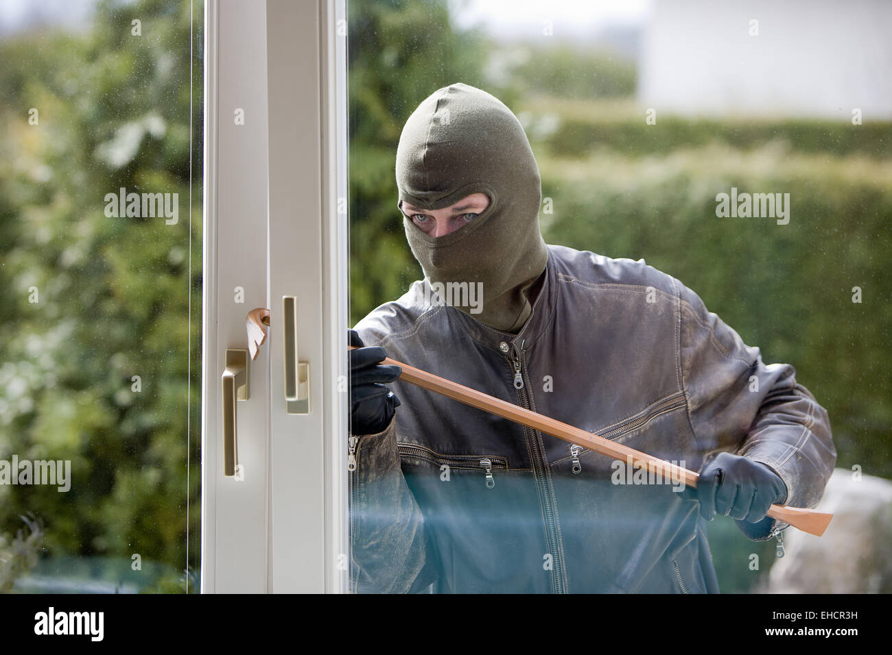 Burglar at a window Stock Photo