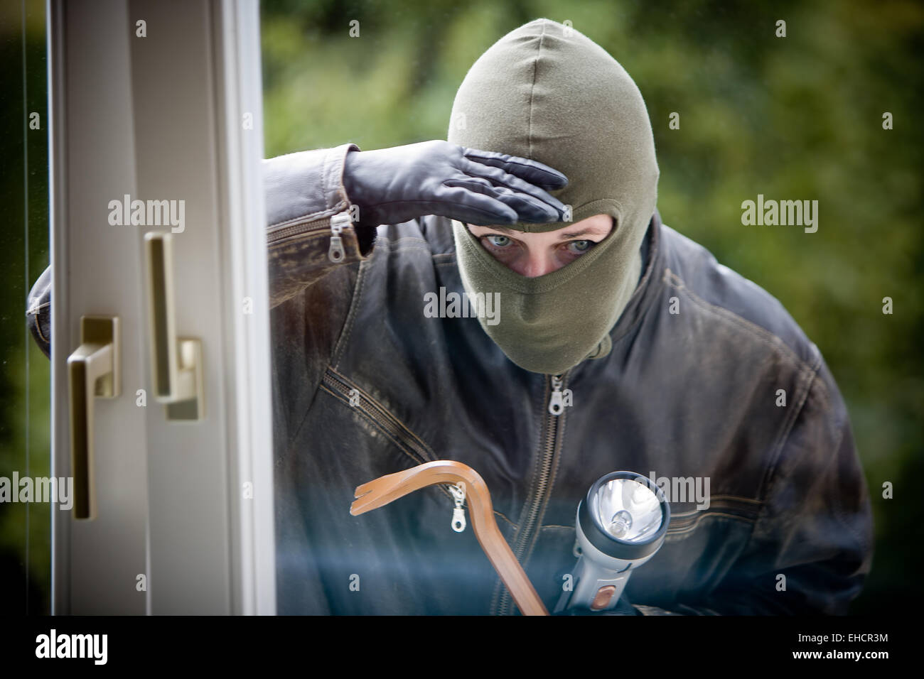 Burglar at a window Stock Photo