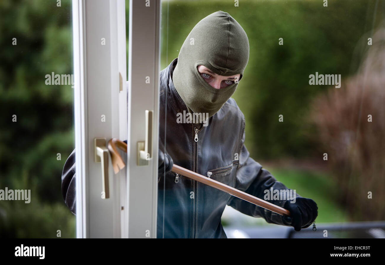 Burglar at a window Stock Photo