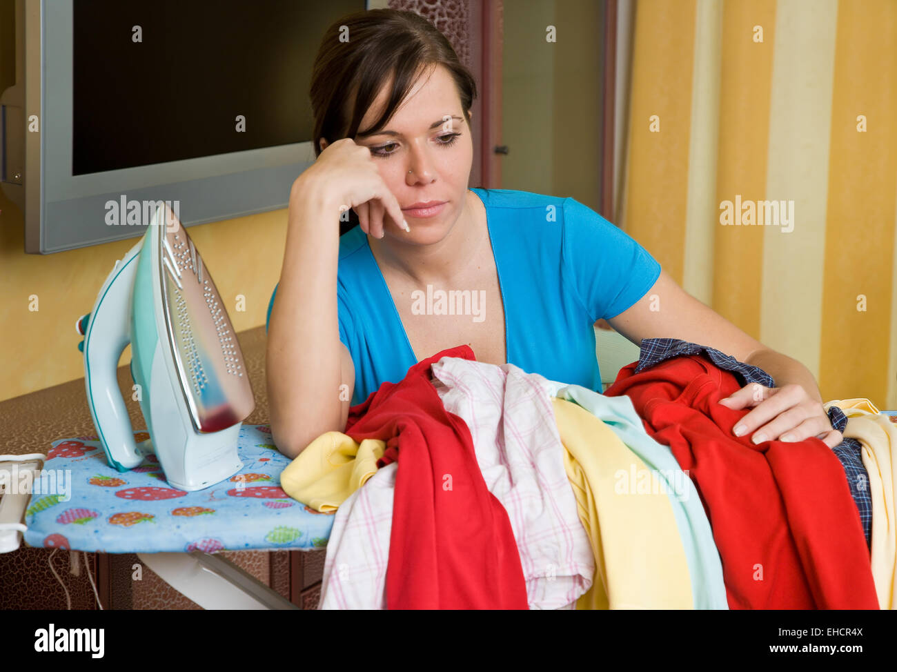 Woman during ironing Stock Photo