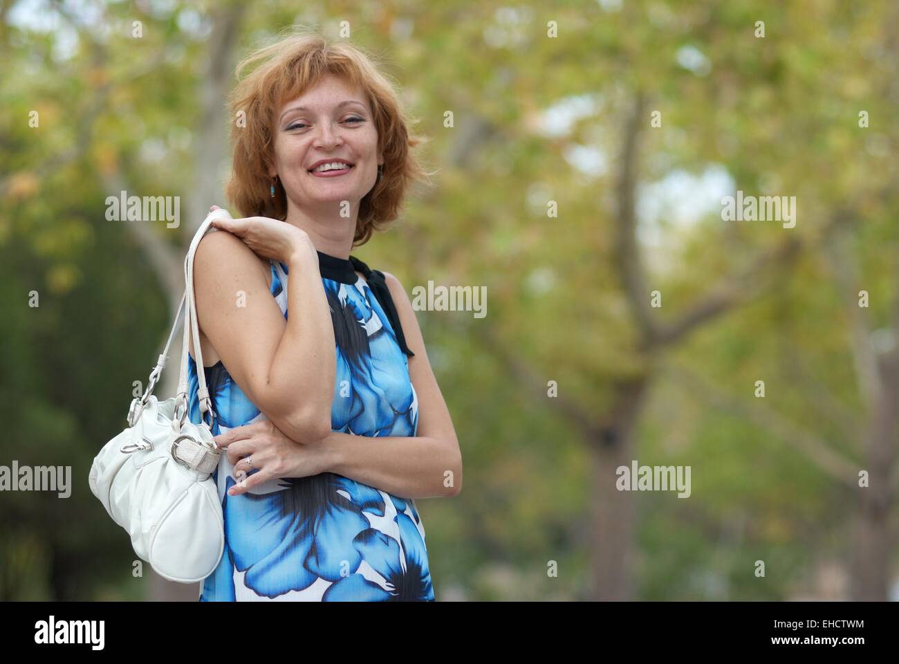 Young woman walking in autumn park soft background Stock Photo - Alamy