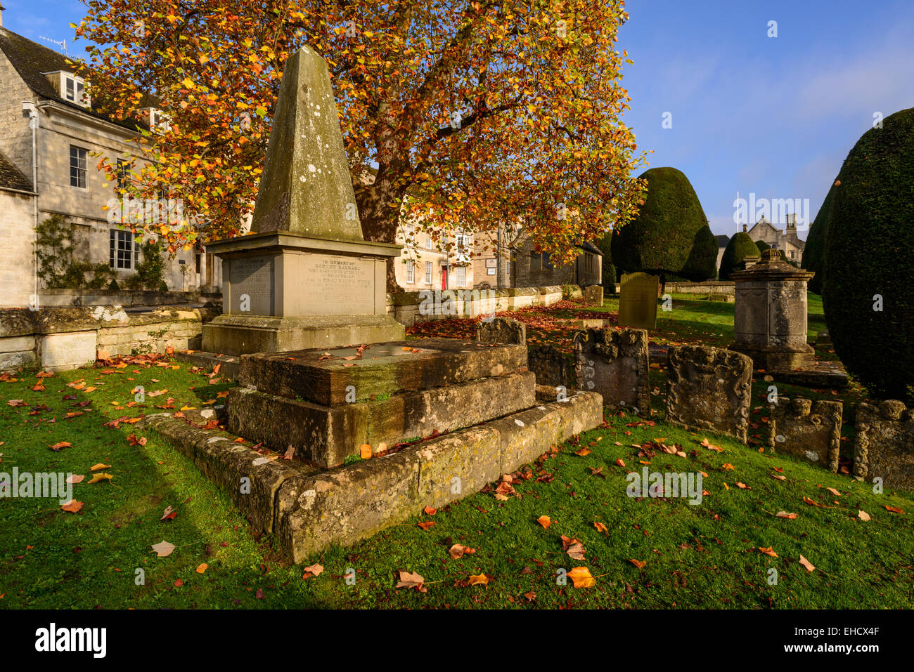 Cotswold stone buildings and St Mary's Churchyard in autumn, Painswick, Gloucestershire, UK Stock Photo