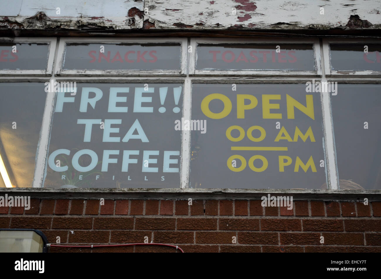 Window of Greasy Spoon Cafe, with free tea and coffee refills, open all hours Stock Photo