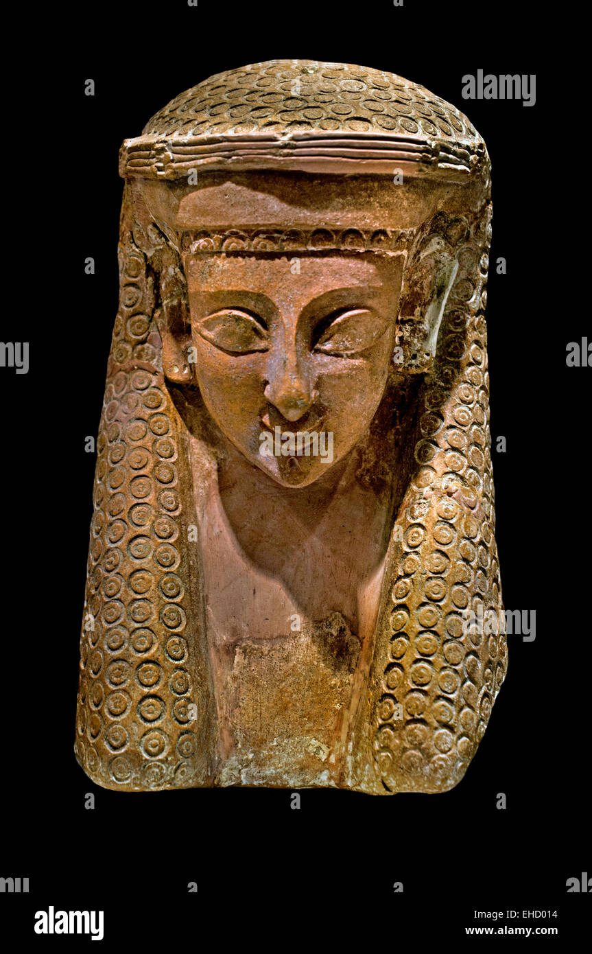 This mask known as a protome mask , clearly combines Egyptian influence in the moulding of the hair with characteristics of Greek archaic style, such as almond shaped eyes 6th century BC   Musee National du Bardo Tunisia  Carthage Phoenicia (Phoenician trading city in North Africa capital Carthaginian Empire ) Stock Photo