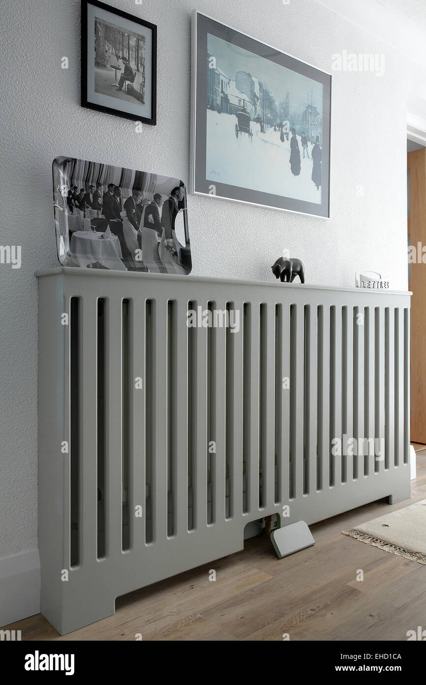 A Wooden radiator cover hiding a radiator in a hallway in a UK home