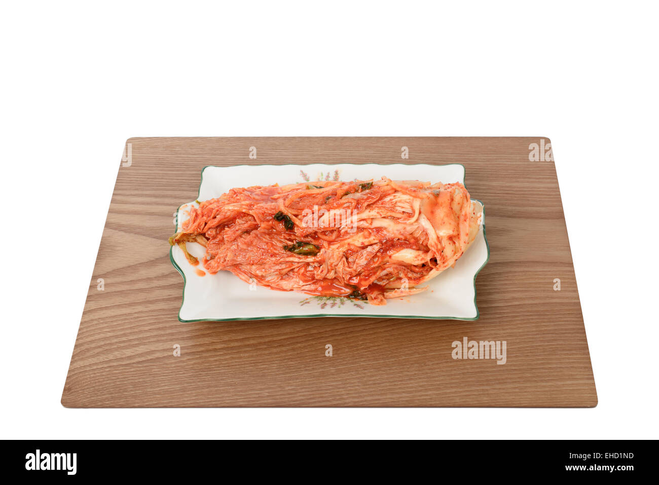uncut red Gimchi on a plate, isolated on white Stock Photo