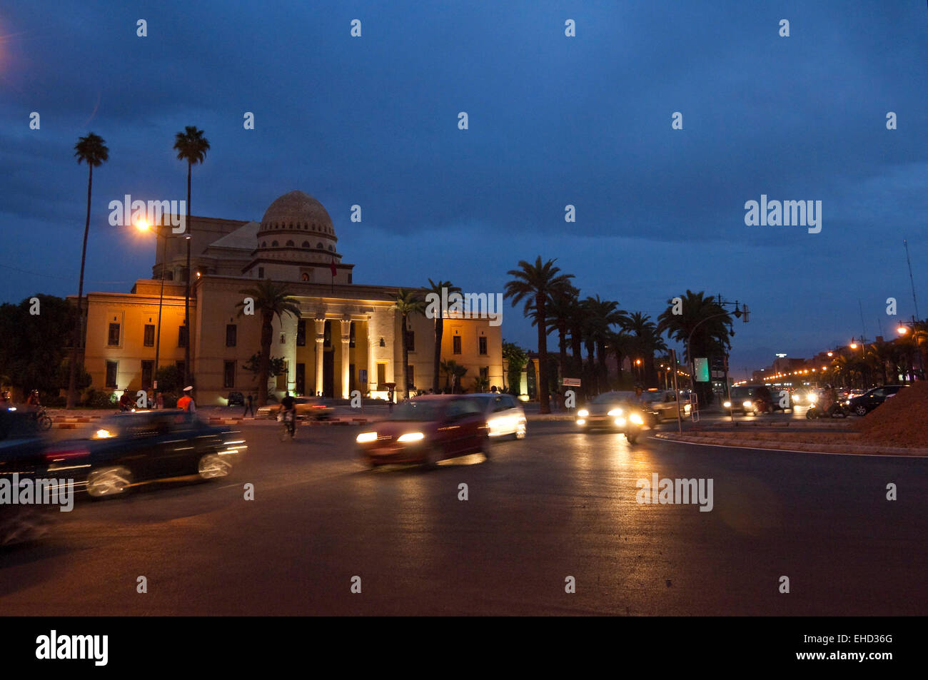 Horizontal streetscape of the Theatre Royal in Marrakech at dusk with motion blur of passing traffic. Stock Photo