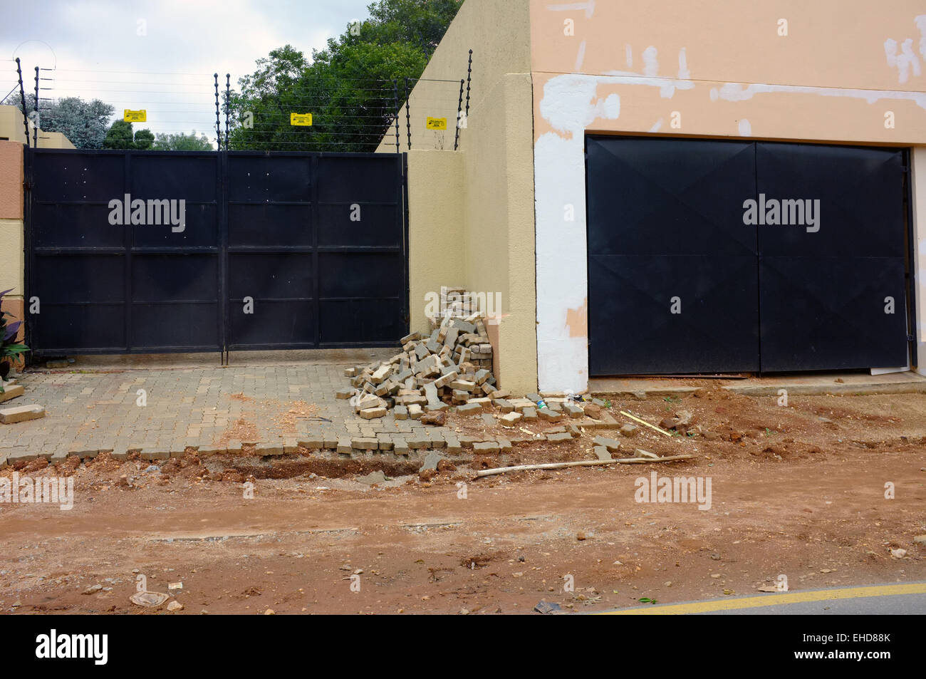 A pile of rubble by the entrances to gated South African homes. Stock Photo