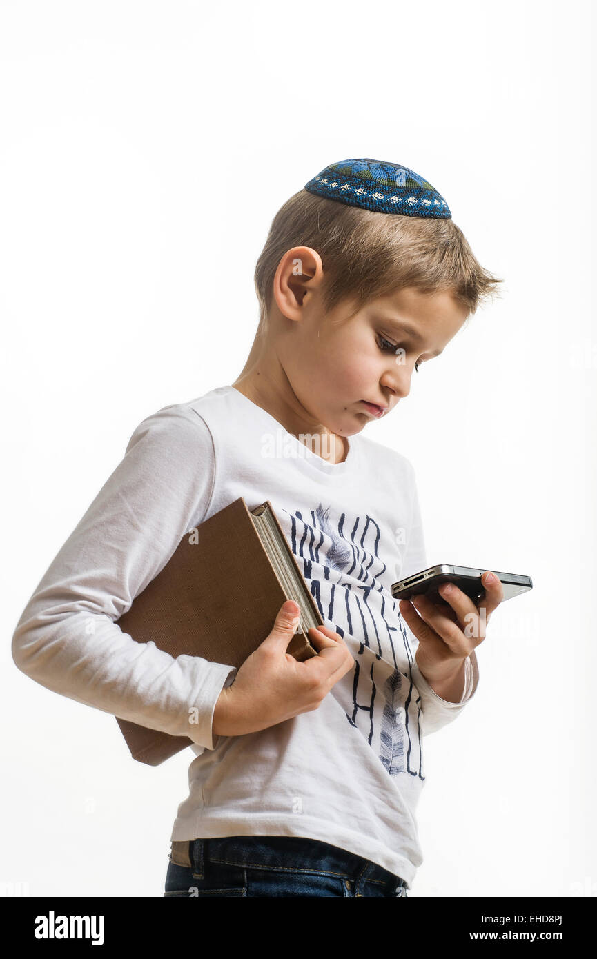 studio portrait of white boy with Jews kipa or yarmulke with mobile ...