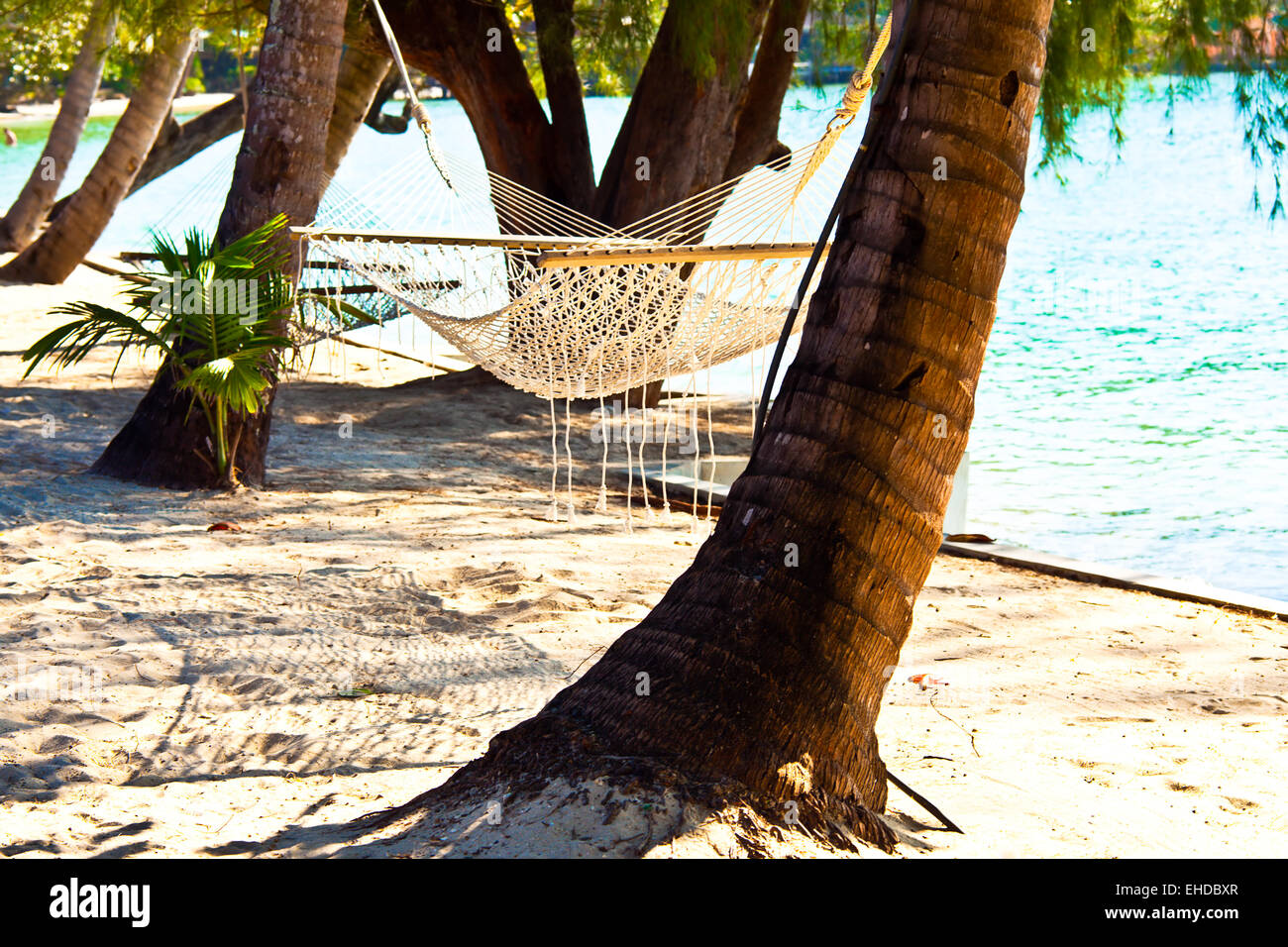 Nice straw hammock on the tropic beach Stock Photo