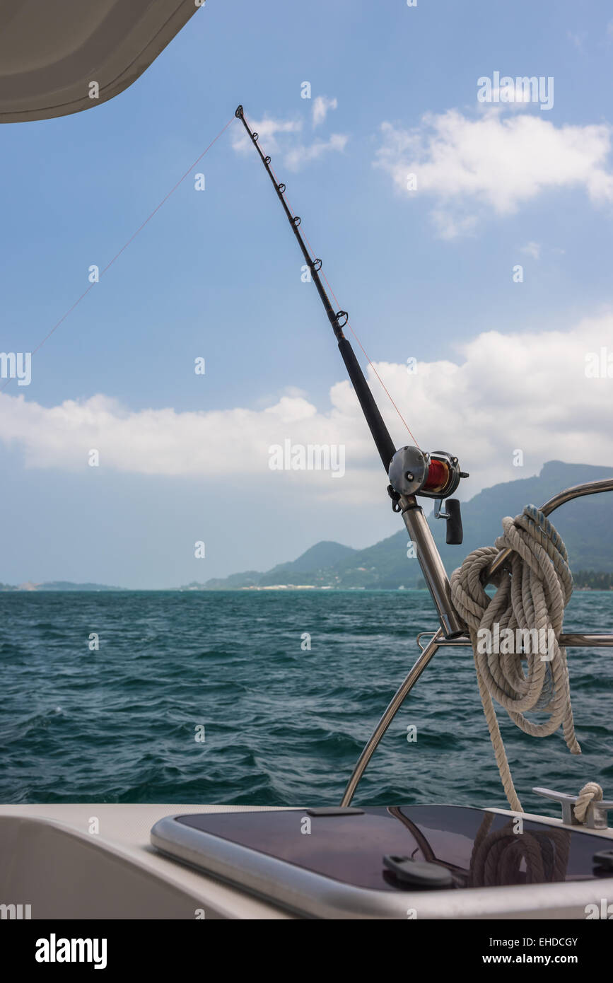 Sailing Rod Fishing rod and reel on a sailing yacht. Vertical shot Stock Photo - Alamy