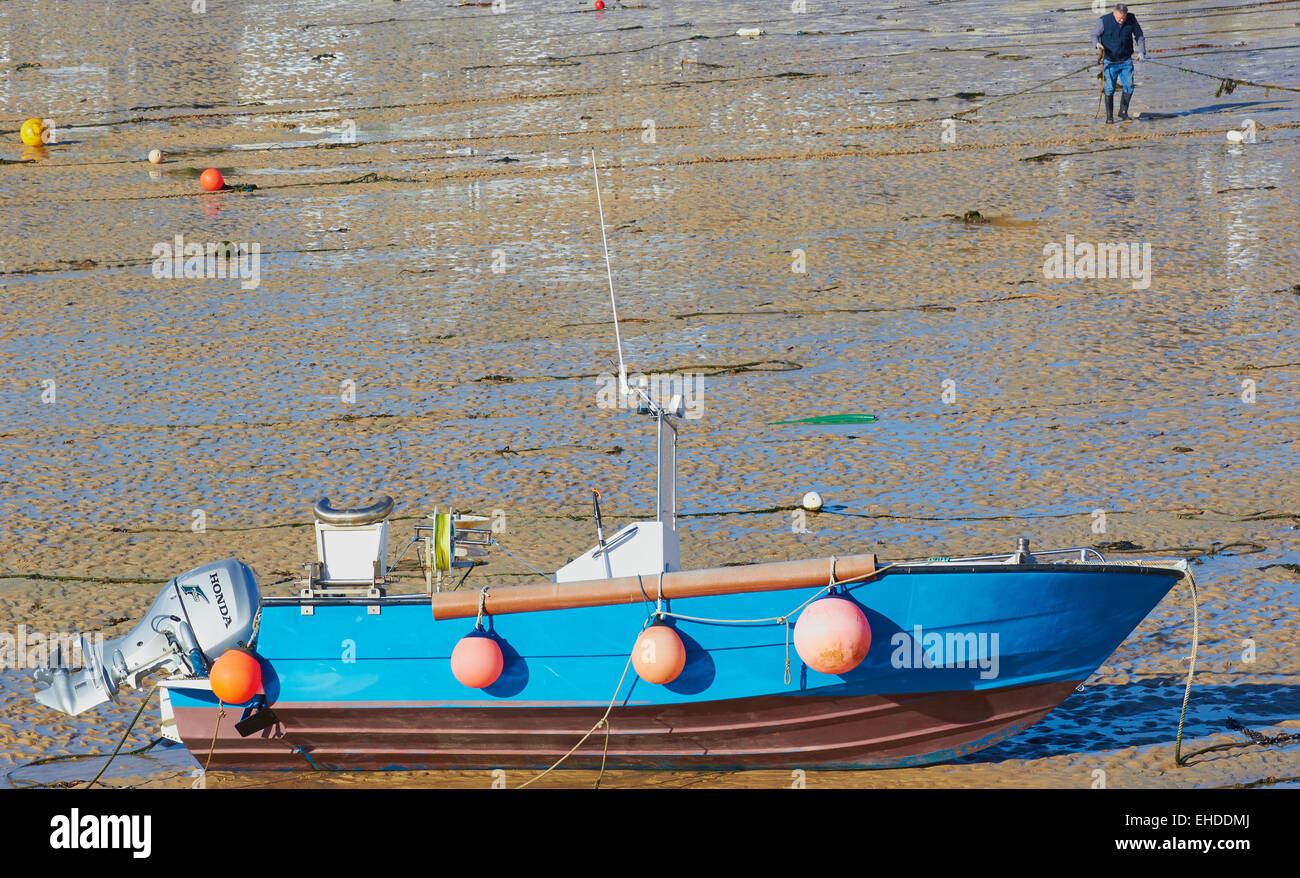 Fishing boat at low tide on the harbour beach St Ives Cornwall England Europe Stock Photo