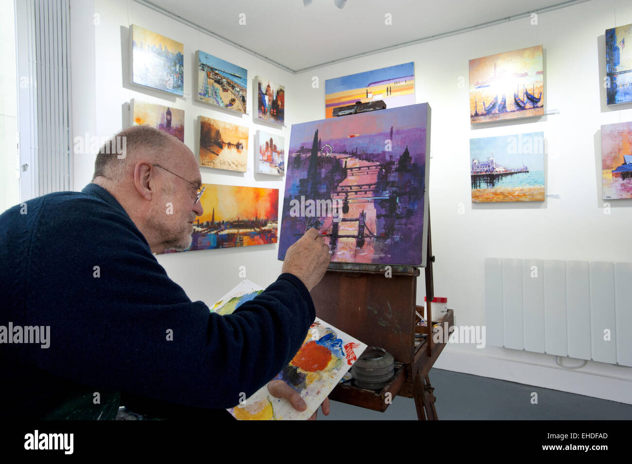 Picture by Roger Bamber : 21 February 2015 : Brighton Artist Colin Ruffell works on an Acrylograph of a Painting of Tower Bridge and the River Thames in London plus other paintings on display during his one man show at 35 North, a Contemporary fine art gallery in Brighton. Stock Photo