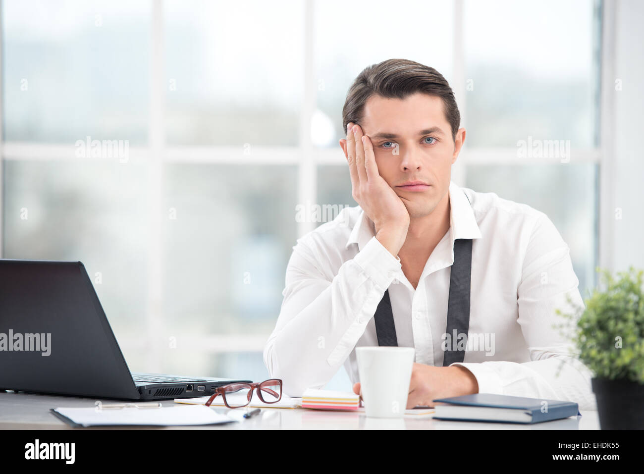 businessman is bored while working with computer stock photo