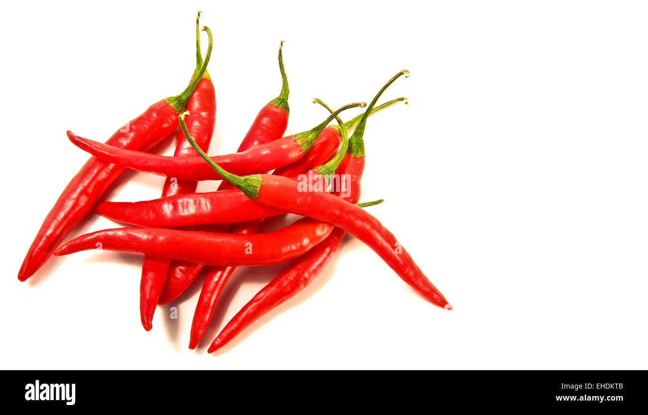 Red peppers laying against a white Stock Photo
