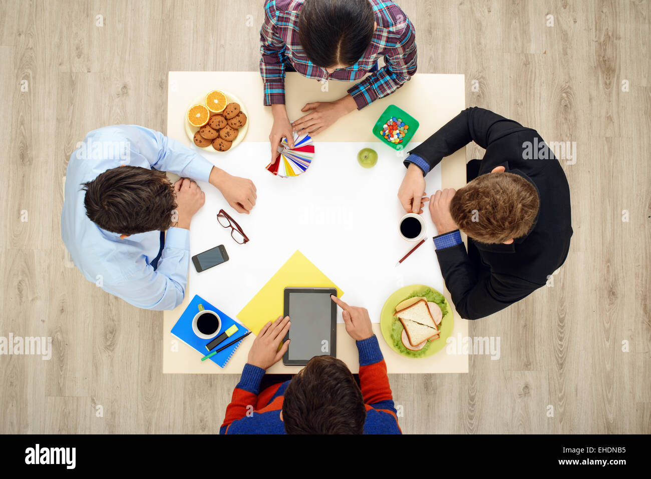 Top view table with creative people Stock Photo - Alamy