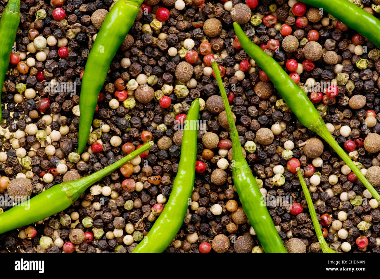 Red and green peppers on pepper background Stock Photo - Alamy
