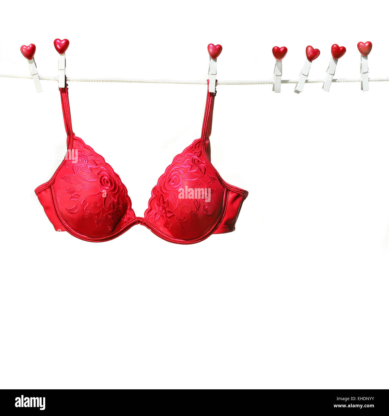 Fancy red bra hanging on clothesline Stock Photo - Alamy