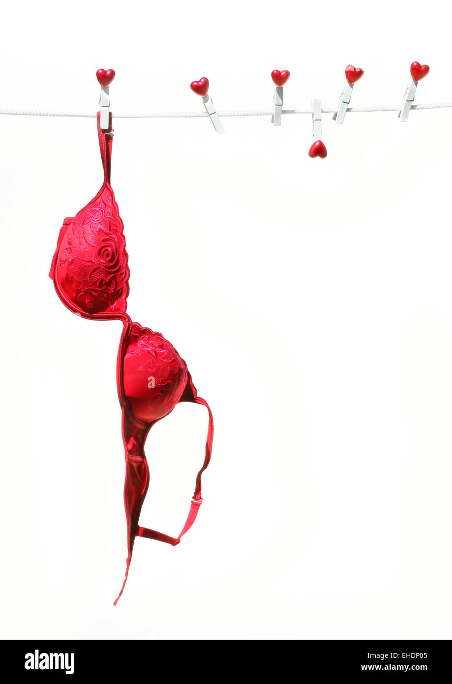 Red brassierre hanging on clothesline Stock Photo