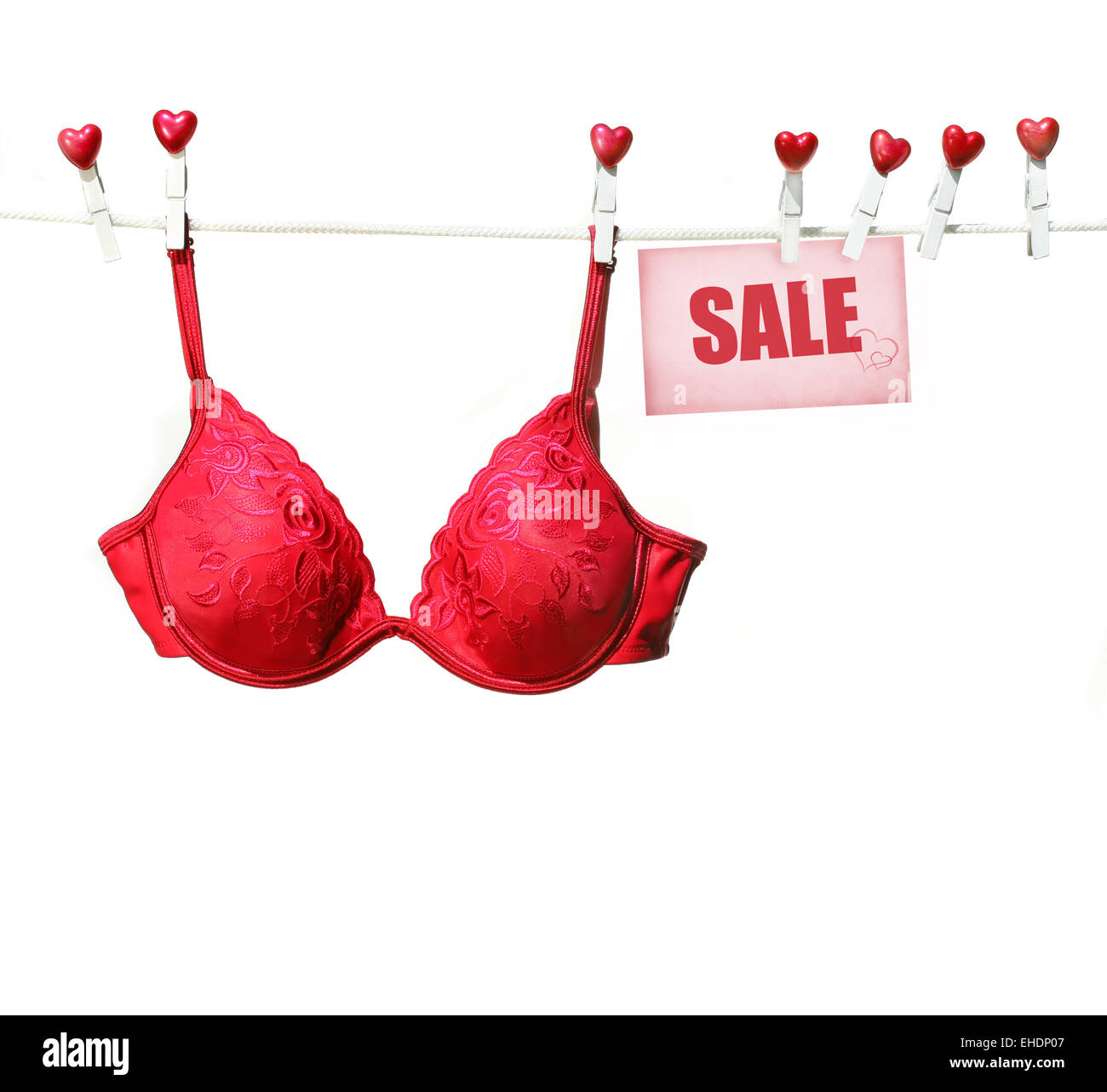Fancy red bra hanging on clothesline Stock Photo