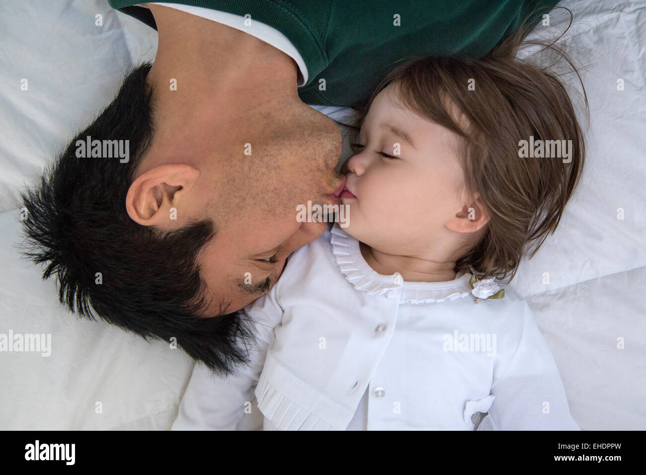 Dad kissing his toddler girl Stock Photo