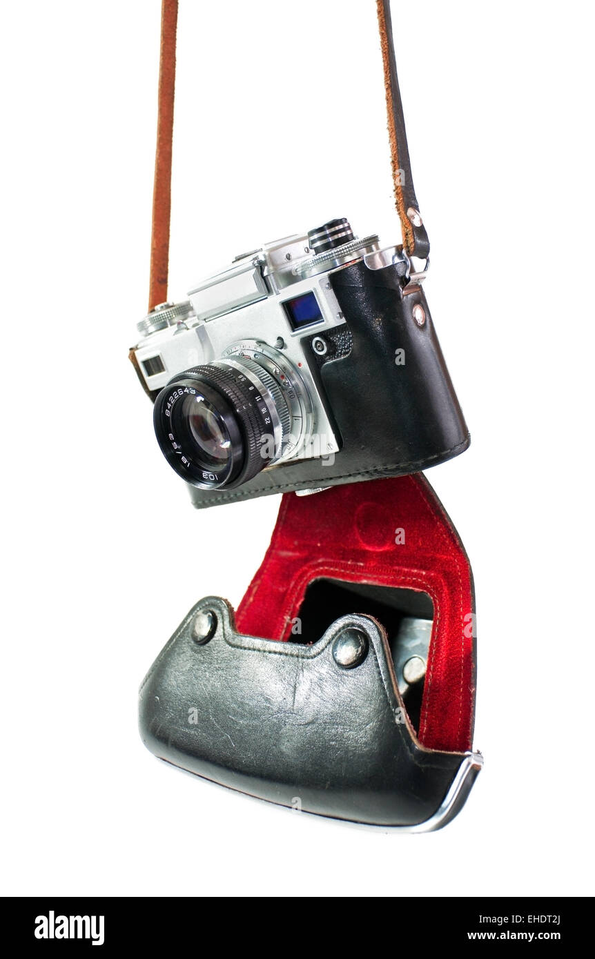 Old Film SLR Camera in a Worn Case, 35mm Film Reel, Lens Cap, Top
