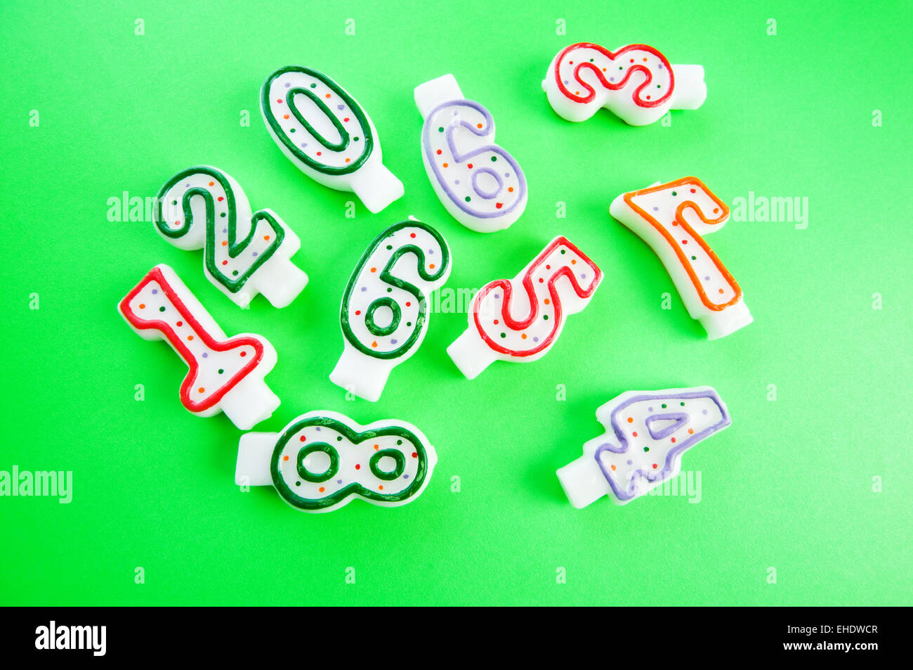 Birthday candles against colourful background Stock Photo - Alamy