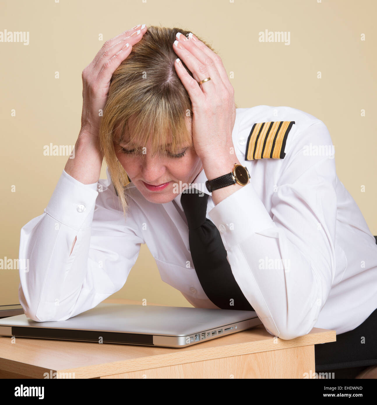 Tired female airline pilot wearing insignia of a captain Stock Photo